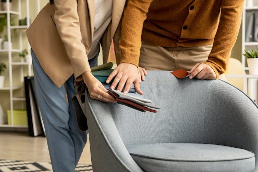Man and woman choosing material for chair