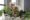Woman maintaining indoor plant pots of herbs