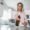 girl spraying on kitchen slab
