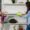 woman and girl cleaning shelf