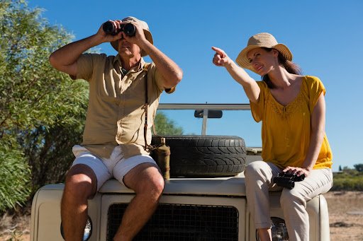 man and woman enjoying view at jungle