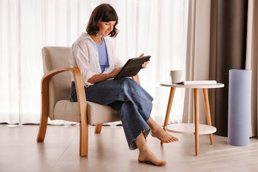 Woman using tab in a stylish chair