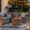 Cozy outdoor sofa seating with candles and hanging lights – perfect patio ideas for creating a warm and inviting outdoor space
