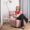 Woman smiling while reading a book on a reading chair