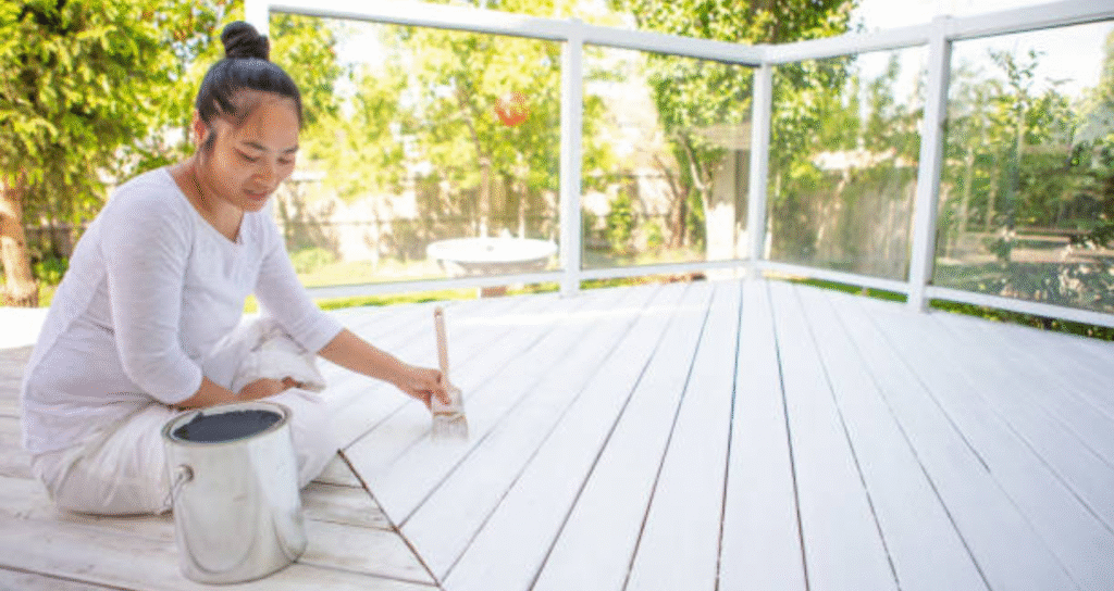 girl painting a deck