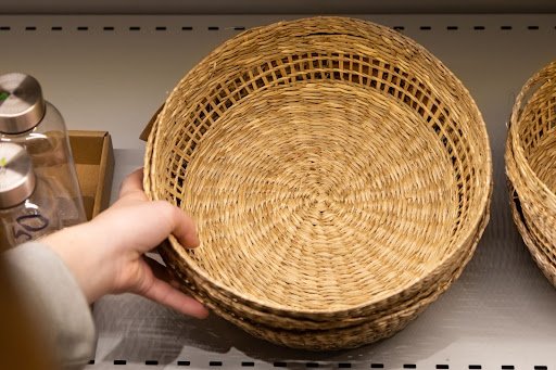 woman keeping tiered basket in small kitchen