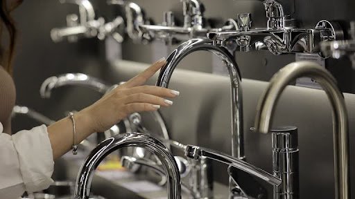 woman checking best kitchen faucet