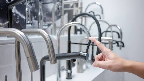 man checking durable kitchen faucet