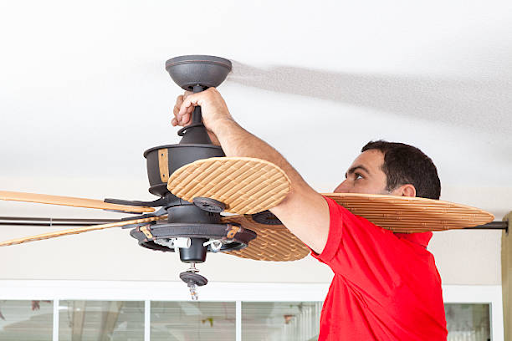man working with a ceiling fan