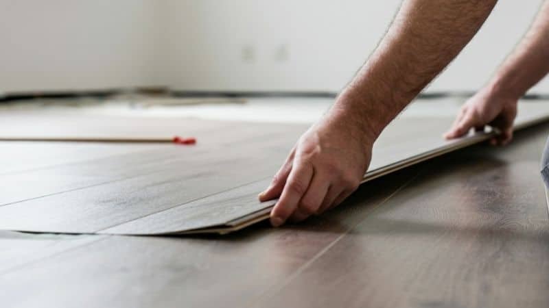 Close-up view of peel-and-stick vinyl flooring being installed